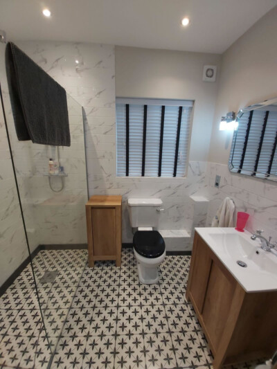 White wooden blind with black tape in bathroom