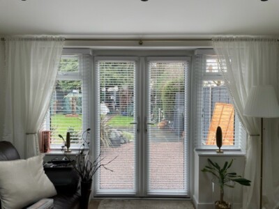Venetian blinds fitted over patio door and side windows