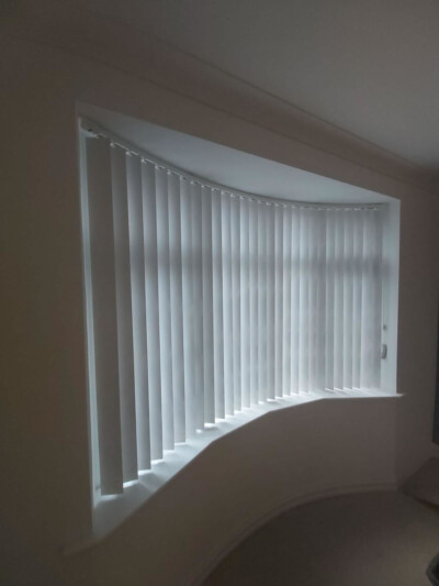 Vertical blinds with curved rail