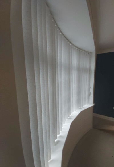 Vertical blinds with curved rail